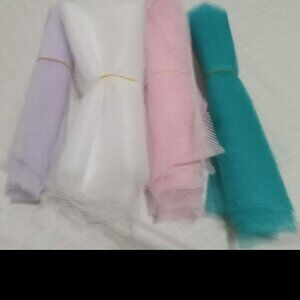 4 lengths of tulle: turquoise, white, pink, and mauve, fabrics